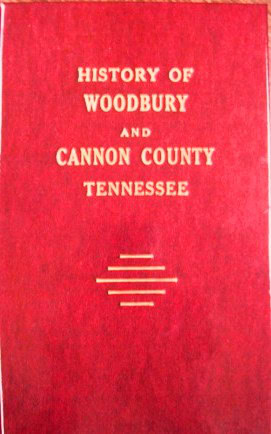 A red book cover with gold text that reads: History of Woodbury and Cannon County Tennessee, with three horizontal gold lines beneath the title.